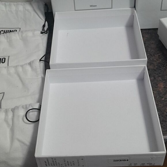 4 Moschino Deluxe Boxes, 4 Deluxe Dust Bags, and 1 and one Enclosure. main image 4
